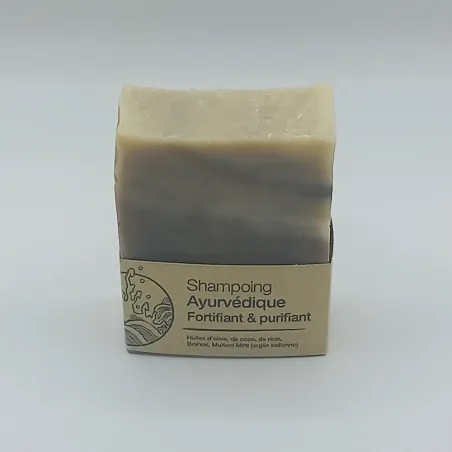 Shampooing ayurvédique posé verticalement sur un fond nautre